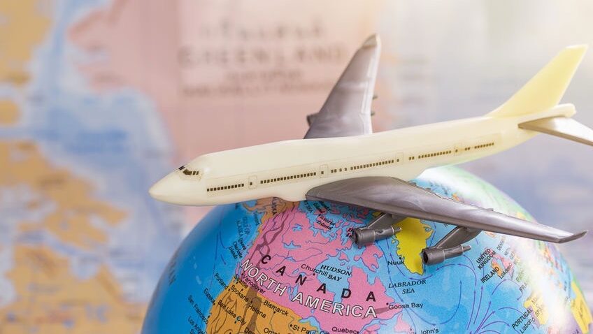 カナダの地図が見える地球儀の上を飛ぶ飛行機の模型。留学をきっかけに世界へ広がる旅のイメージ